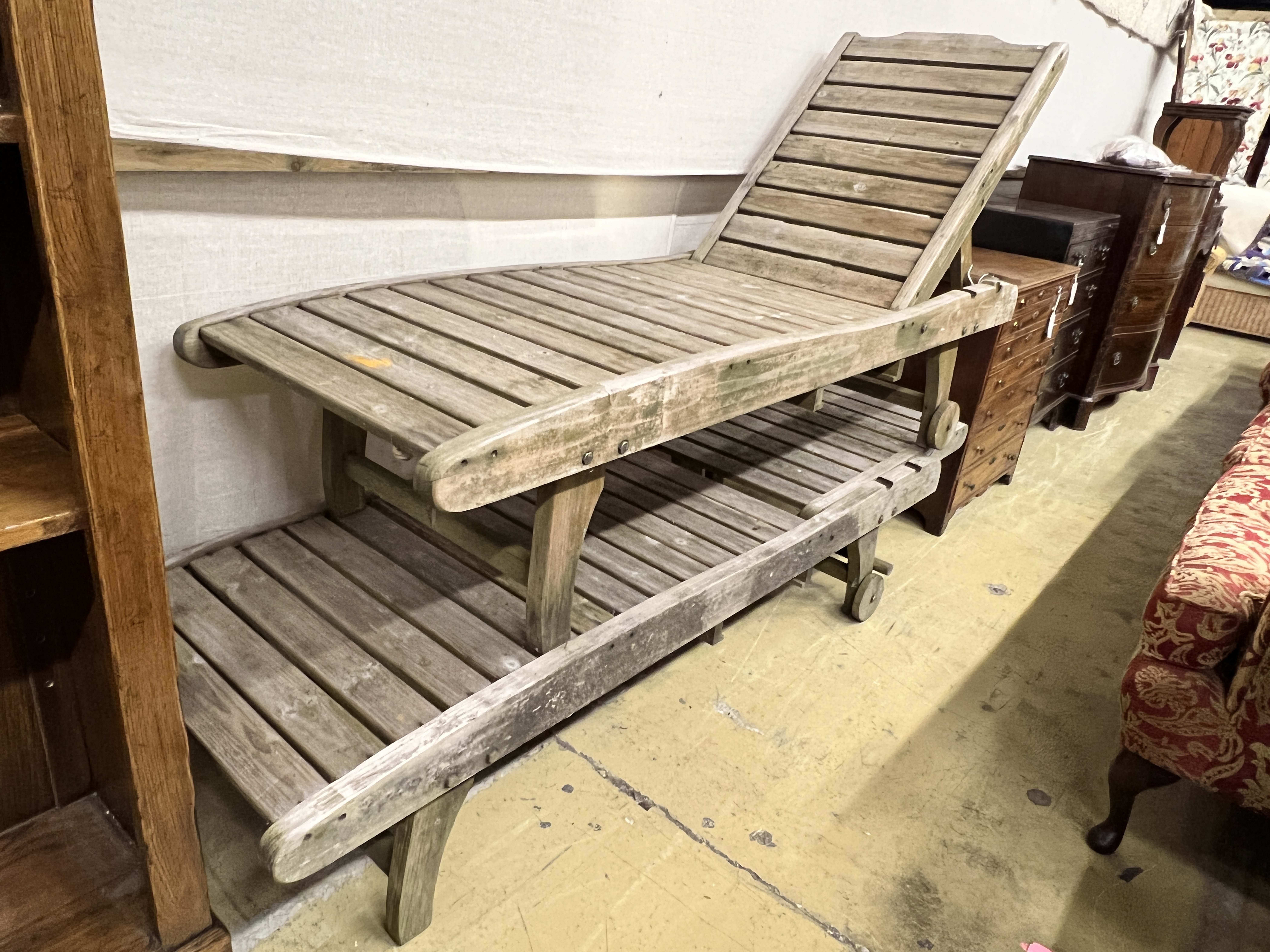 A pair of weathered teak garden loungers, length 180cm, width 58cm
